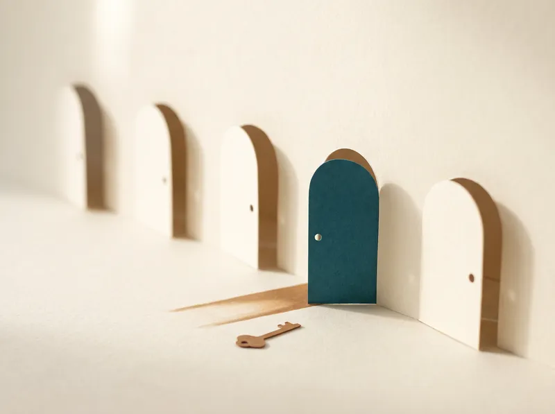 A row of paper doors closing, the nearest one teal.